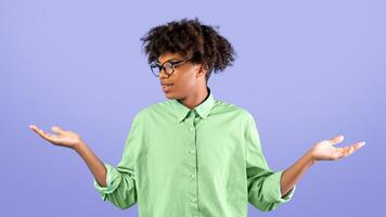 Make best decision. African american guy making scales with his empty hands, comparing options standing over blue studio background, copy space photo