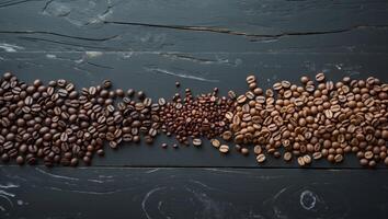Assorted coffee beans arranged on dark textured tabletop showcasing a variety of colors and types from darker to lighter shades photo
