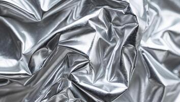 Shiny crumpled metallic surface texture close up photo