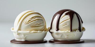 Two ice cream scoops with chocolate sauce dripping from them photo