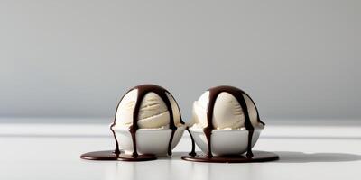 Two ice cream scoops with chocolate sauce dripping from them. photo