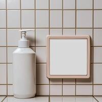 White pump bottle and blank wall mounted panel in a bathroom setting photo