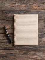 Blank notepad and pen on rustic wooden table photo
