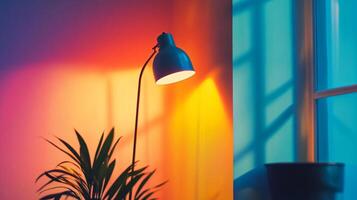 A lamp is lit up in a room with a plant in the foreground photo