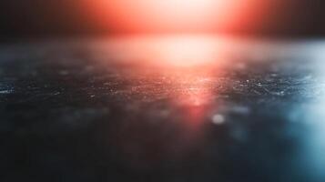 A blurry image of a dark surface with a red and orange background photo