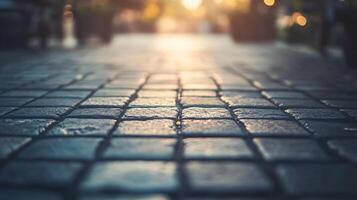 A close up of a brick sidewalk with a few potted plants in the background photo