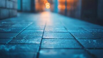A blurry image of a wet sidewalk with a blue sky in the background photo