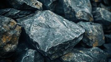 A pile of rocks with a few of them being grey and some of them being black photo