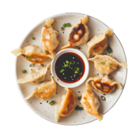 A plate with dumplings and sauce on it png