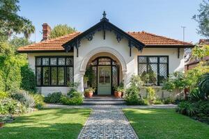 Elegant victorian house with lush garden and mosaic path on sunny day photo