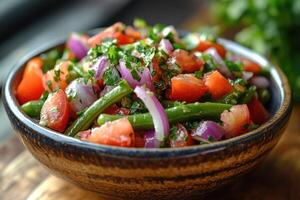 Green bean salad with tomatoes, red onions and parsley in rustic bowl photo