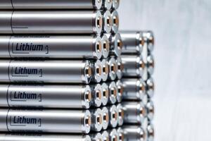 Lithium batteries forming a stack on grey background photo