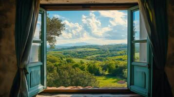 Open window overlooking rolling green hills and trees in tuscany photo