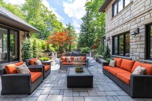 Elegant backyard patio featuring comfortable seating and lush greenery photo