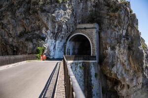 The road and tunnel on sunny day of the Amalfi Coast, Mediterranean, Italy. photo