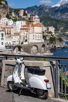 White scooter with background of Amalfi Coast, Italy. photo