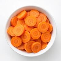 Top View of Sliced Carrots in a Bowl on a White Background photo