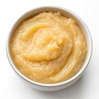 Top View of Creamy Applesauce in a Bowl on a White Background photo
