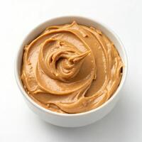 Top View of Creamy Peanut Butter in a Bowl on a White Background photo