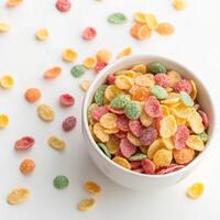 Top View of Colorful Cereal in a Bowl on a White Background photo