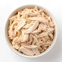 Top View of Shredded Chicken in a Bowl on a White Background photo