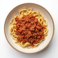 Top View of Spaghetti Bolognese in a Bowl on a White Background photo