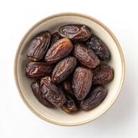 Top View of Dates in a Bowl on a White Background photo