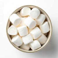 Top View of White Marshmallows in a Bowl on White Background photo