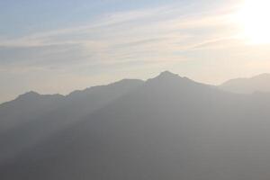 A plane flying over a mountain range photo