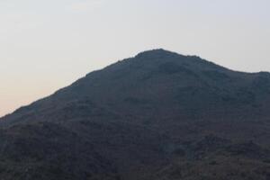 A person flying a kite on a hill. photo