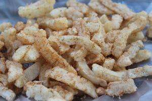 A close up of some fries on a paper photo