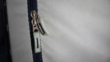 a photo of a zipper on a bag that has two