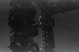 BW photo of a big machine in fog with urban design and dark theme