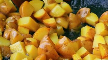 Stirring fried yuilba with a wooden board. Frying golden potatoes. video
