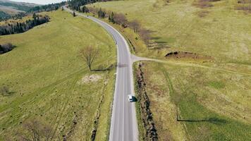 road in the mountains. tourist route in a beautiful area. Paved road and car moving on the road outside the city. video