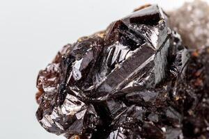Macro of mineral Sphalerite stone on microcline on white background close up photo
