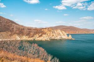 View of the vastness of the Pacific Ocean from th high seashore. High cliffs on the shore of the Pacific Ocean. photo