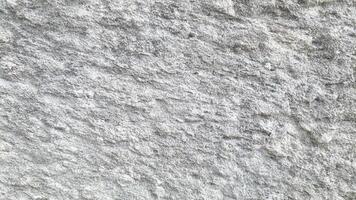Weathered stone surface with rough textures and natural erosion, creating a realistic background for industrial and game design. photo