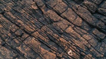 High-resolution textured rocky surface background with deep cracks, ideal for geological design, stone textures, or abstract natural patterns for creative projects. photo