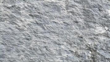 Light grey textured stone surface with natural grains and subtle patterns, suitable for modern, minimalist, and architectural backgrounds. photo