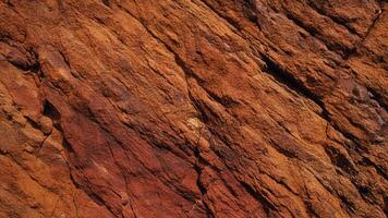Warm-toned rock texture with rich red and brown hues, showcasing rugged geological patterns perfect for use in design, architecture, and nature-inspired background projects. photo