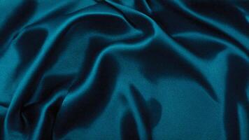 Dark turquoise silk background with deep shadows and highlights, providing a luxurious and rich aesthetic perfect for high-end branding, decor, and textile designs. photo