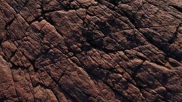 Textured rock surface with detailed sedimentary layers and warm earthy hues reflecting the beauty of natures geological formations for use in architecture, backgrounds, and design projects. photo