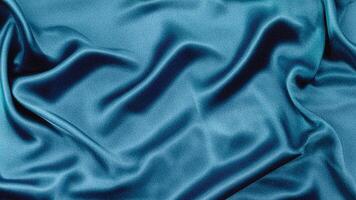 Luxurious flowing light blue silk fabric background with smooth folds and elegant waves, ideal for fashion, decor, digital design, and sophisticated branding. photo