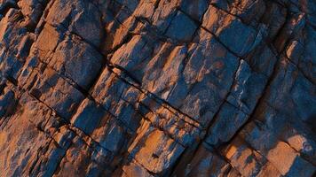 Cracked stone surface with rich mineral deposits and layered textures, great for geological patterns, abstract stone backgrounds, and architectural inspirations photo