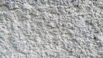 Smooth light stone surface with natural grain, ideal for minimalist, modern, and architectural design backgrounds or textures. photo