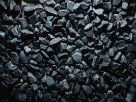 Abstract texture of dark stones forming a natural background in various shapes and sizes photo