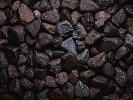Natural abstract texture showcasing dark stones arranged in a unique pattern photo