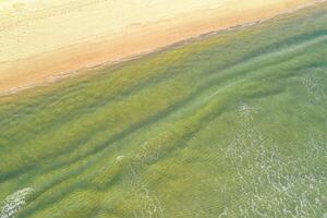 overhead view of beach with vibrant turquoise water, concept of aerial drone view tranquility background photo