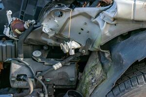 detail of the front left front wing of a car part of a car wrecked in an accident at a scrapyard photo